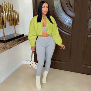 Detail view of neon green faux fur cardigan with grey ribbed crop top and matching trousers