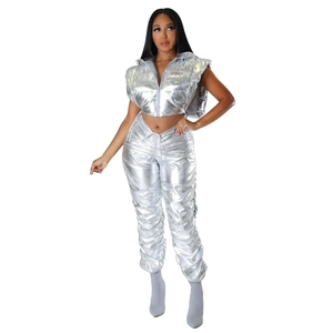 Detail of silver metallic puffer vest set with hooded zip jacket and ruched pants