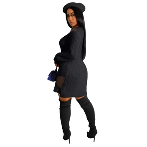 Detail of black knit dress with unique mesh cut-outs on shoulder and side hemline
