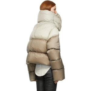 Detail of two-tone padded jacket featuring a high stand collar and bicolor patchwork design