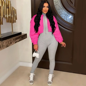 Detail of hot pink faux fur jacket paired with a grey ribbed knit slim-fit jumpsuit