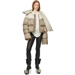 Detail of short color-block puffer jacket with unique scarf-style collar and sleek texture