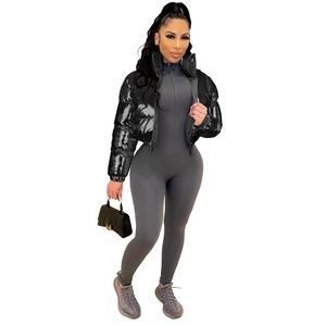 Short black puffer jacket with shiny texture paired with grey ribbed bodysuit and sneakers