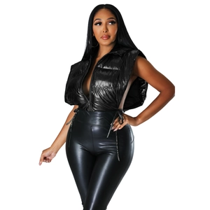 Detail of shiny black puffer vest with side lace-up drawstrings and high neck collar
