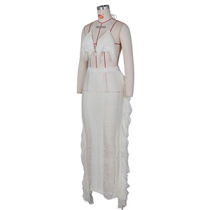 Detail of white crochet fringe two-piece set featuring knit halter top and maxi skirt