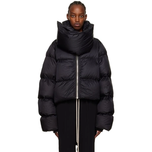 Detail of oversized black puffer jacket featuring exaggerated high funnel neck and metal zipper