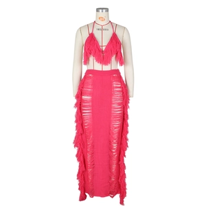 Detail of the rose red knit two-piece set featuring tassel fringe and hollow out crochet style