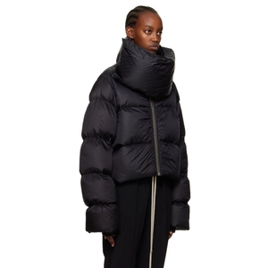 Detail of minimalist matte black puffer jacket featuring a massive funnel neck scarf design
