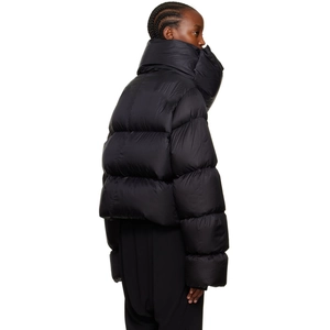 Detail view of high padded scarf-style collar on women's black winter puffer jacket