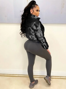 Women's trendy black shiny puffer jacket and grey ribbed leggings for autumn and winter outfit