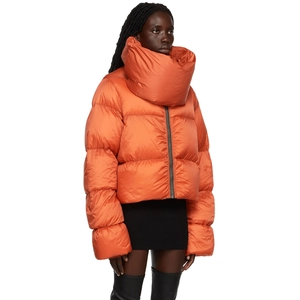 Detail of orange puffer jacket featuring a large wrap-around scarf collar and quilted fabric