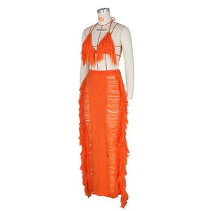 Detail of orange knitted beach set featuring halter neck top and fringe tassel texture