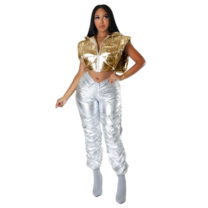 Detail showing metallic gold puffer vest and silver ruched trousers with high-shine texture