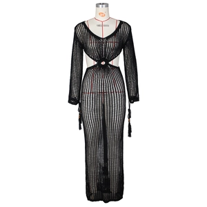 Détail de robe noire en crochet avec motif en maille et pompons perlés élégants