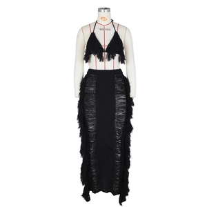 Detailed knit texture of two-piece black beach set with hollow-out design and fringe
