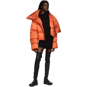 Detail of a bright orange puffer jacket with high collar and quilted satin finish texture