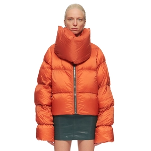 Detail view of the oversized bright orange puffer jacket with high collar and satin finish