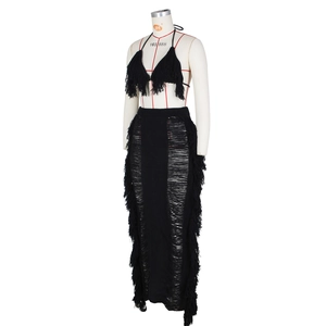Detail of black knit two-piece set featuring fringe trim and distressed hollow out texture