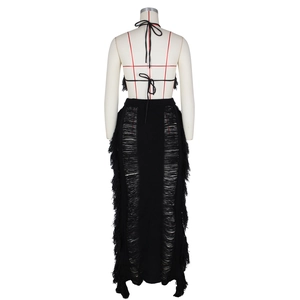 Detail of black crochet knit two-piece set featuring backless top and side fringe skirt