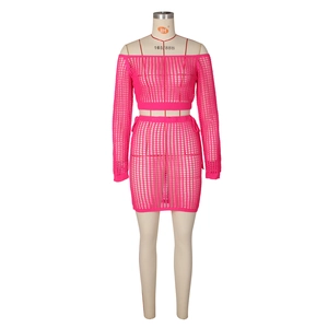 Detailed knit texture of bright pink two-piece crochet beach set with openwork design