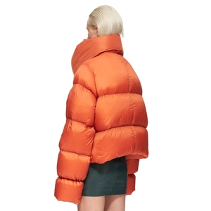 Detail of orange glossy puffer jacket featuring an oversized collar and puffy texture