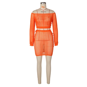 Detail of orange crochet knit two-piece set featuring hollow mesh pattern and long sleeves