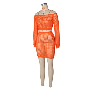 Detailed macro view of orange hollow knit texture on a two-piece beach skirt set