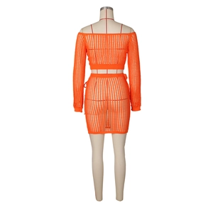 Rear view of orange crochet knit two-piece set featuring cutout texture and drawstring
