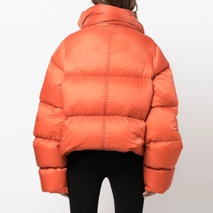 Rear view of an oversized orange padded jacket featuring horizontal quilting and high collar