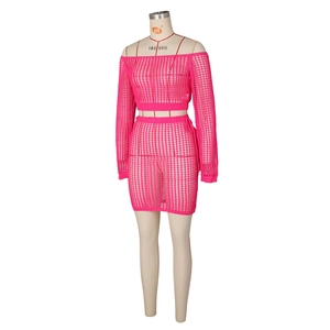 Detailed close-up of neon pink knit beach set with crochet mesh texture and hollow design