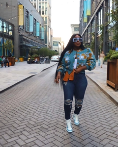 Street style view of a blue cropped jacket featuring 3D floral textures and casual fit
