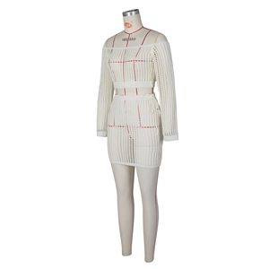 Detail of white crochet knit two-piece set featuring mesh hollow texture and side ties