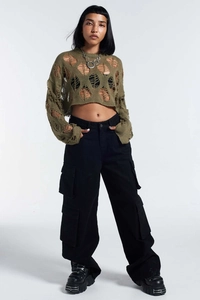 Detail of army green hollow out knit sweater featuring oversized crochet hole patterns