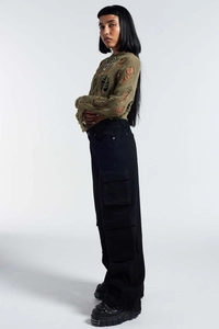 Detail of army green hollow out knit sweater with cargo pants and chunky boots