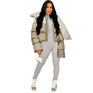 Detailed view of women's short puffer jacket featuring oversized lapels and zipper closure