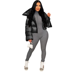 Detailed view of women's black glossy puffer jacket and high collar scarf neck design