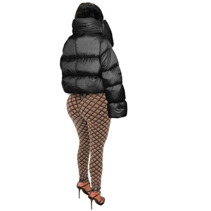 Back view of a cropped black puffer jacket paired with brown diamond pattern leggings