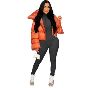 Detail of cropped orange glossy puffer jacket with wide collar and quilted texture
