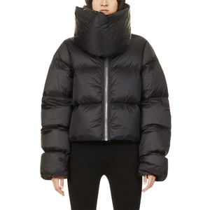 Detail of high oversized neck scarf collar on black puffer jacket with metallic zipper