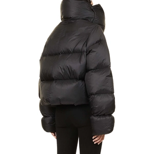 Macro view of women's puffer jacket featuring glossy black nylon and padded high collar