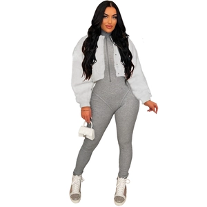 Detailed look at white faux fur jacket paired with a grey ribbed zipper bodysuit