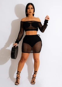 Close-up of the intricate hollow-out knit texture on a black two-piece beach set