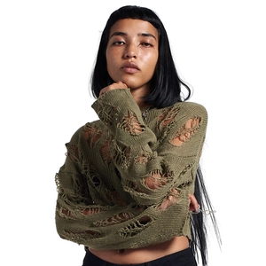 Close-up of army green distressed knit sweater featuring ripped holes and cropped hem