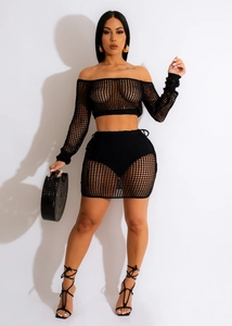 Close-up of black hollow-out crochet two-piece beach set featuring long sleeves and mini skirt
