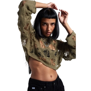 Detail of distressed army green hollow-out knit sweater with punk style frayed edges