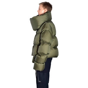 Detail of green puffer jacket featuring a unique oversized wrap collar and quilted texture