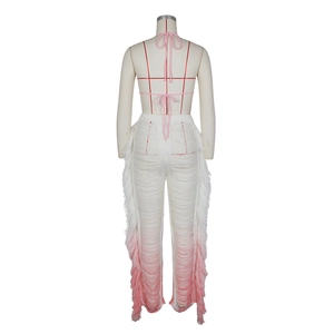 Detail of back design featuring halter neck tie and pink gradient fringe on knit pants