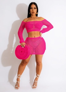 Detail of rose red crochet knit two-piece set featuring off-shoulder top and mini skirt