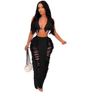 Close-up of black fringe halter top and distressed maxi skirt beachwear set