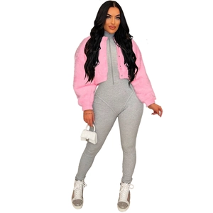Detail of pink faux fur jacket paired with grey ribbed bodysuit and a small white handbag